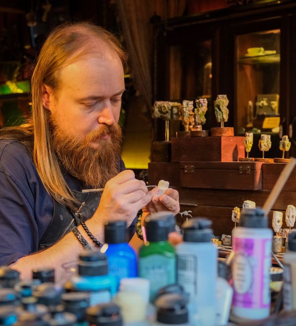 Christian painting a miniature at his workbench