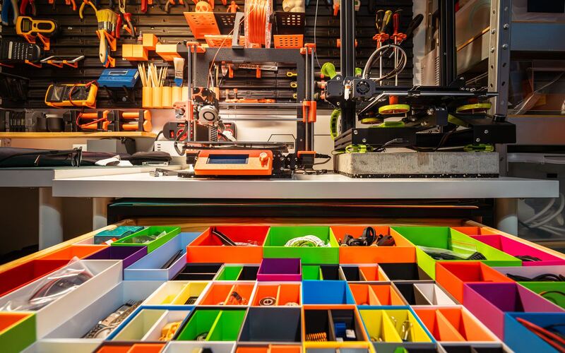 Workshop with a tray of colorful printed organizer bins
