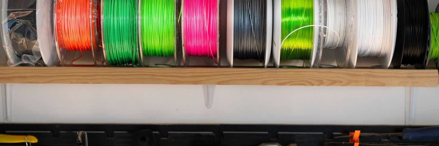 Spools of 3D printing filament in many colors