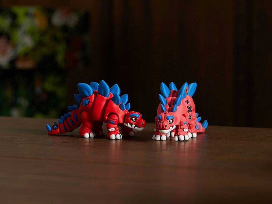 Red and blue articulated stegosaurus toys