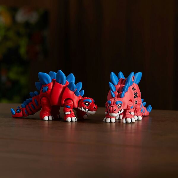 Red and blue articulated stegosaurus toys