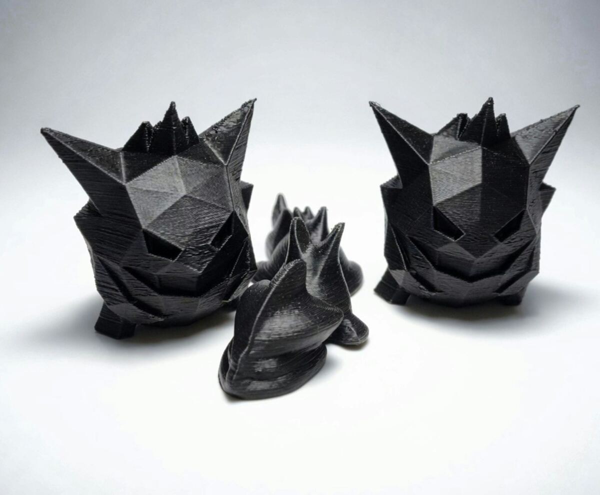 Black faceted figurines on a white background